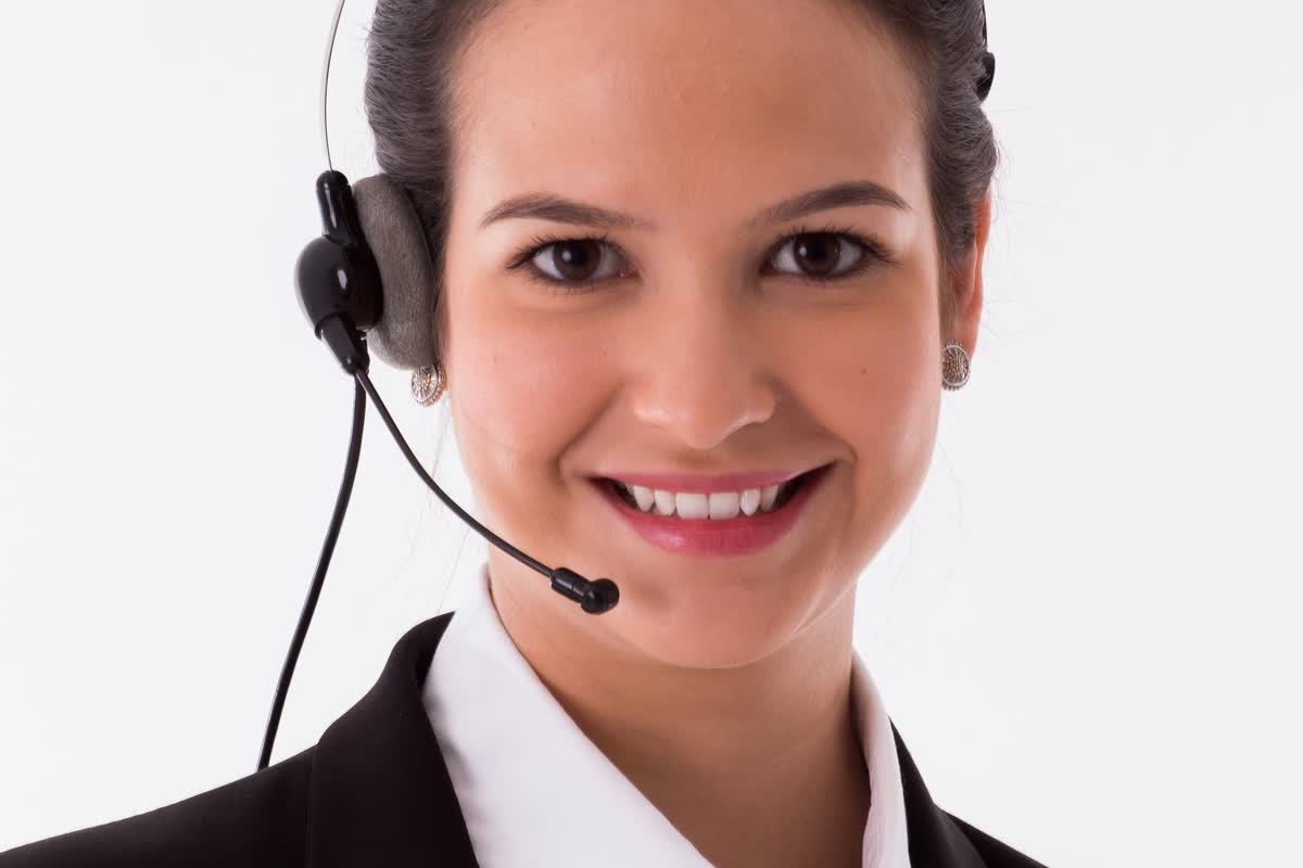A close-up of a person wearing a telephone headset against a plain background: an illustrative image for a customer support desk.