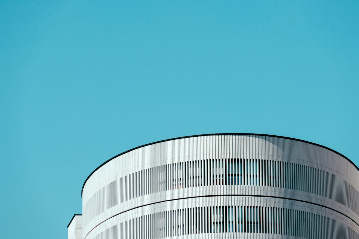 A minimalist cylindrical building against open sky — an illustrative image for clarity and singular focus.