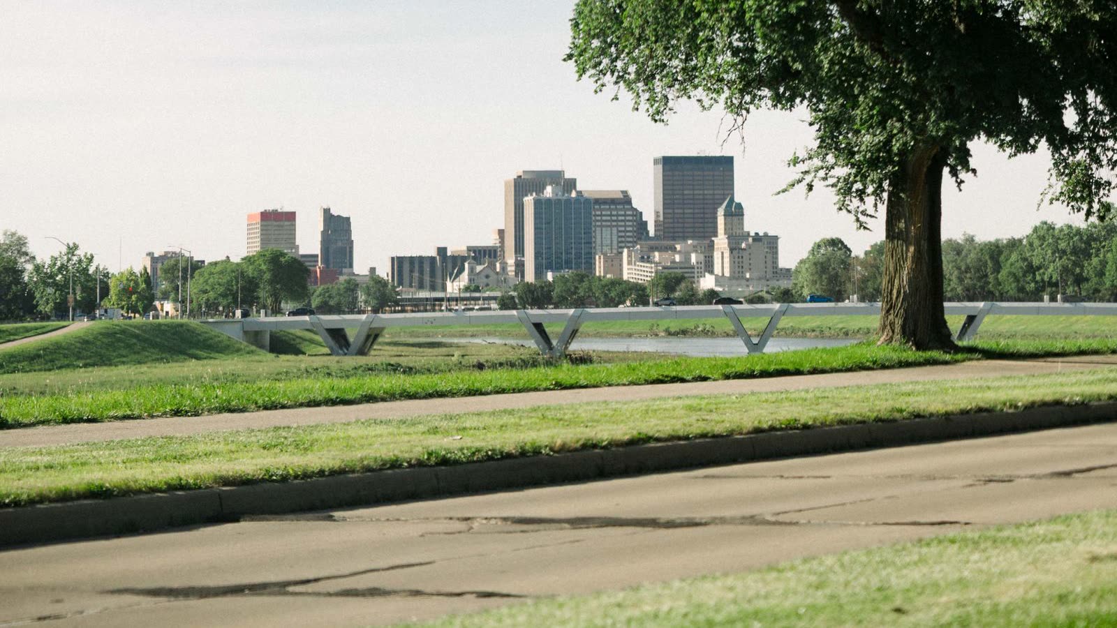 The downtown Dayton skyline seen across the Great Miami River levee on a summer morning, an illustrative image for the firm's Dayton service area.