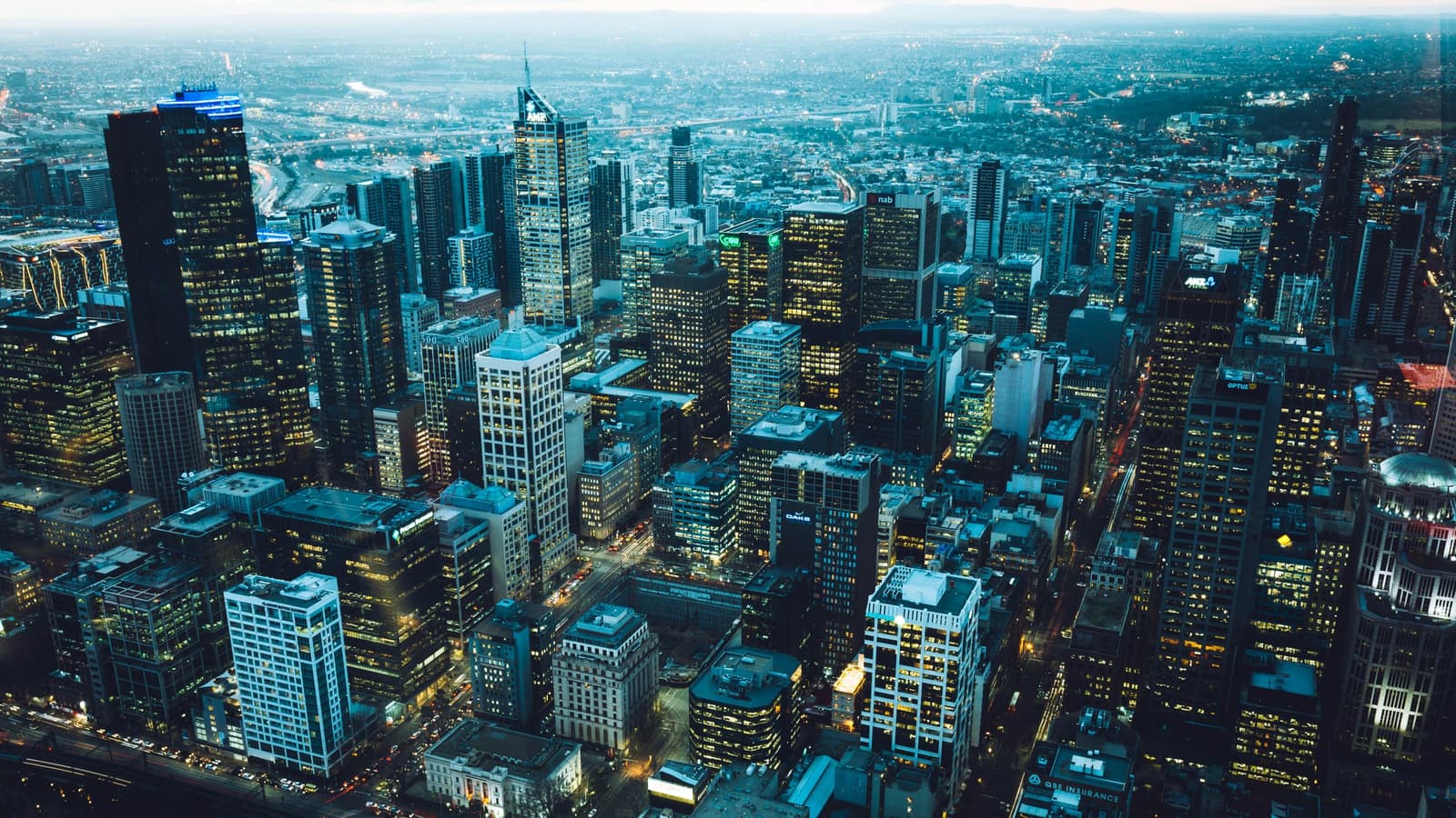 An aerial view of a city skyline lit at dusk — an illustrative image for metropolitan scale.