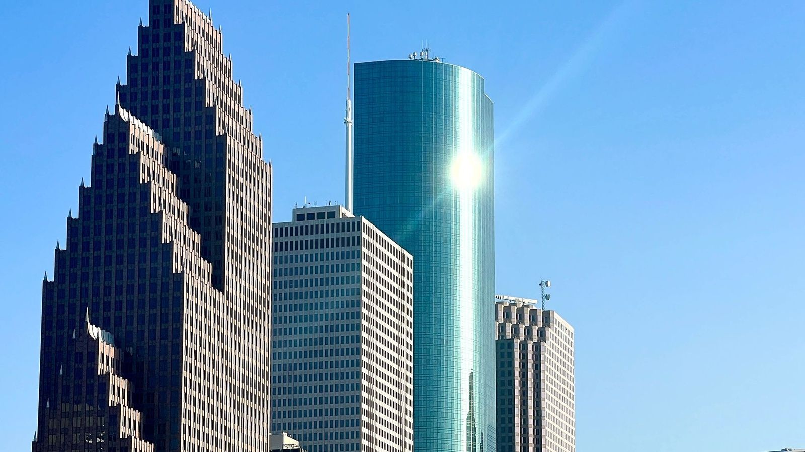Sunlight on the glass and stone towers of downtown Houston, an illustrative image for the firm's Houston service area.