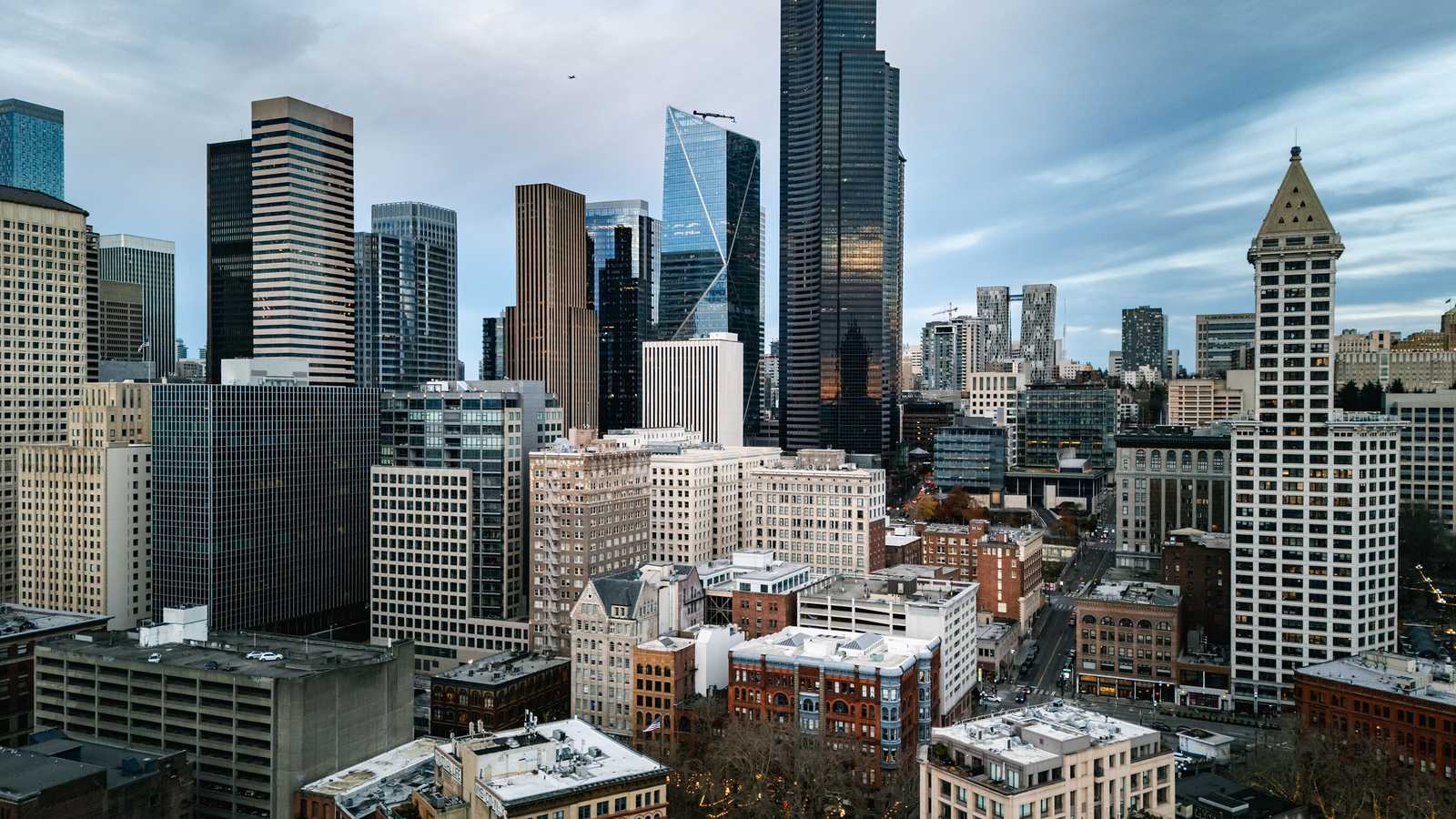 Downtown Seattle towers rising above the Pioneer Square blocks at dusk, illustrative of the Seattle area.
