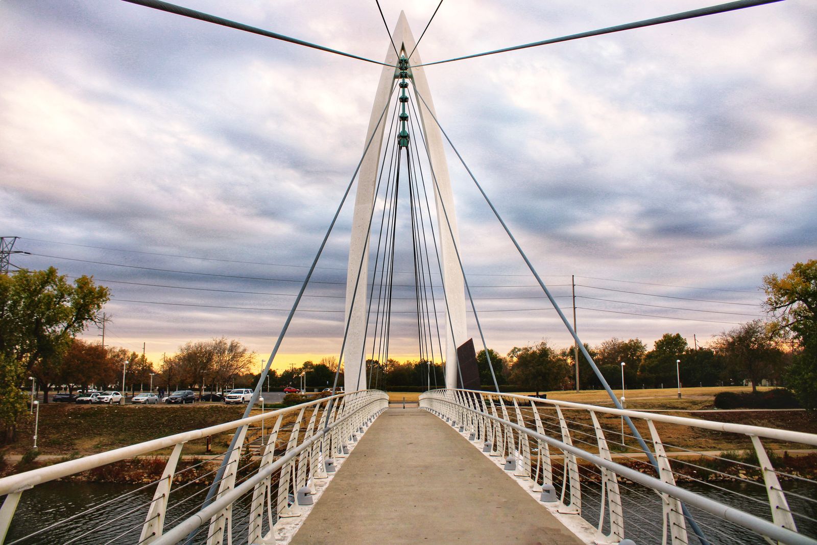 The Keeper of the Plains pedestrian bridge over the Arkansas River in Wichita at dusk, an illustrative image for the city's riverfront.