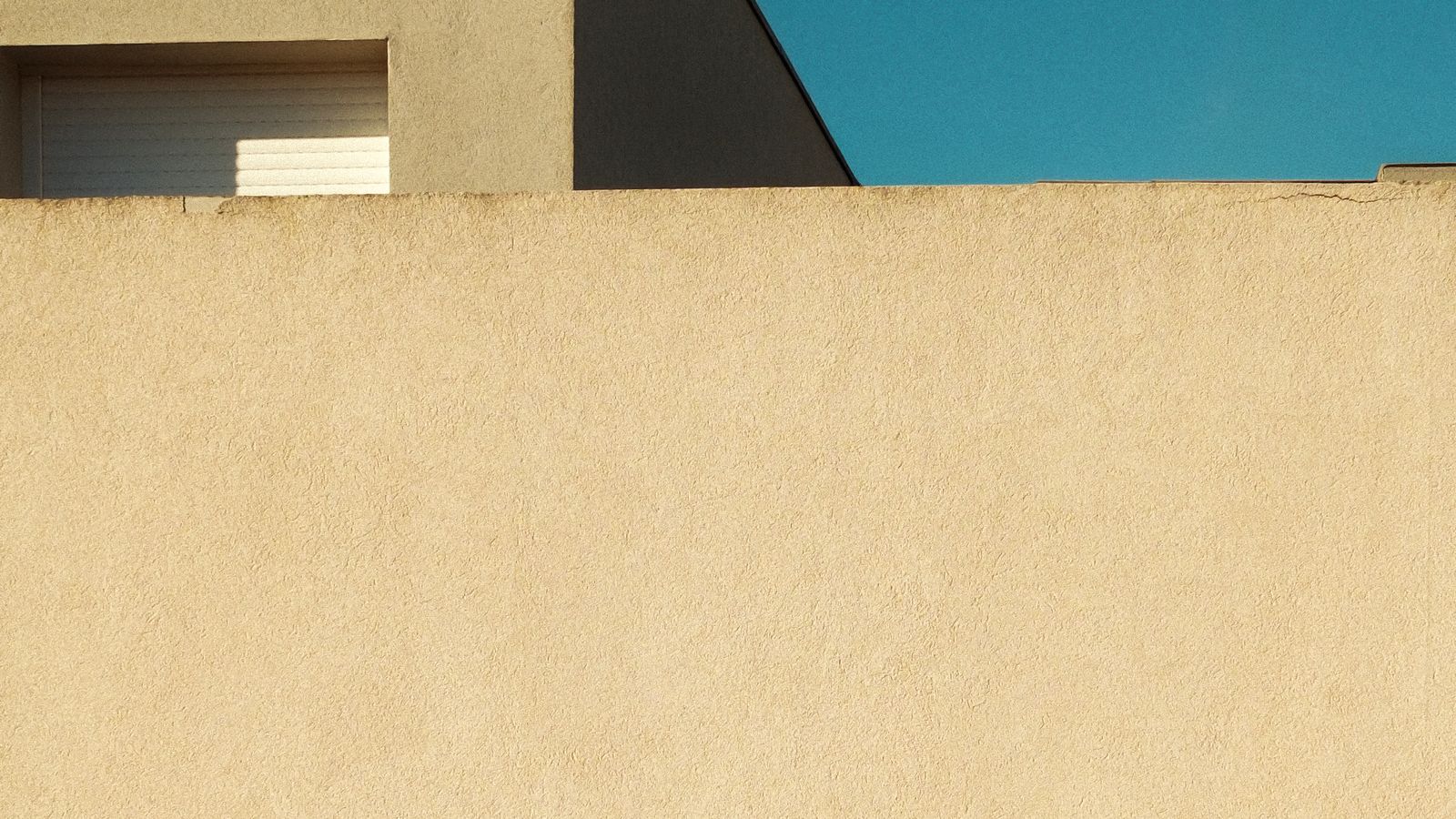 A compact architectural volume in clear light, an illustrative image for a small unit of work standing alone.