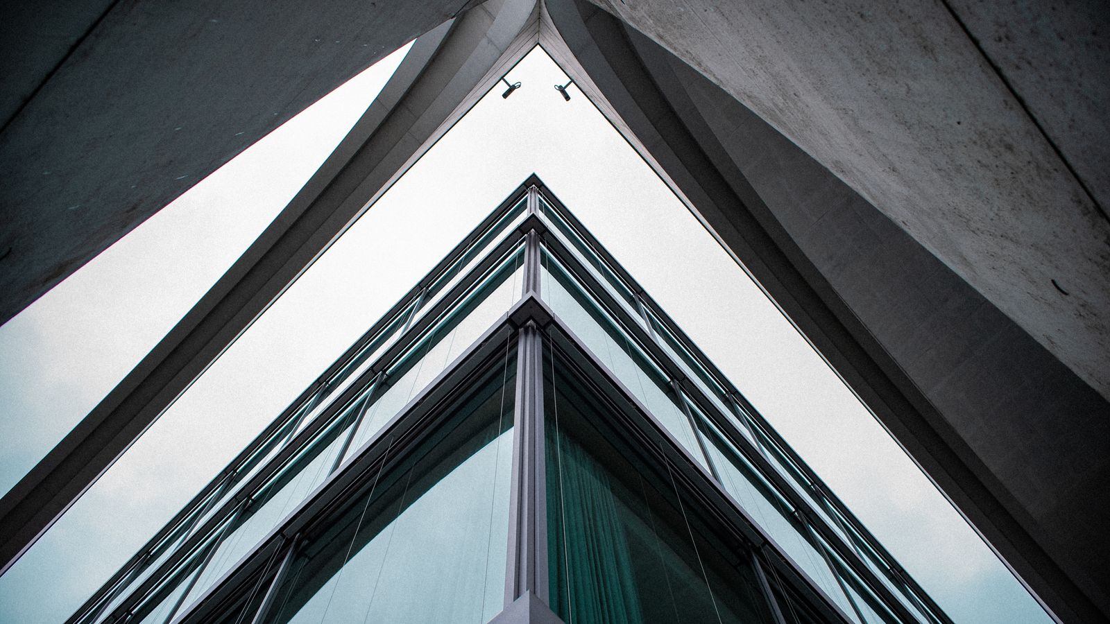 Low-angle view of a modern glass-and-steel building, its facade receding in ordered lines — an illustrative image for structured, disciplined thinking.