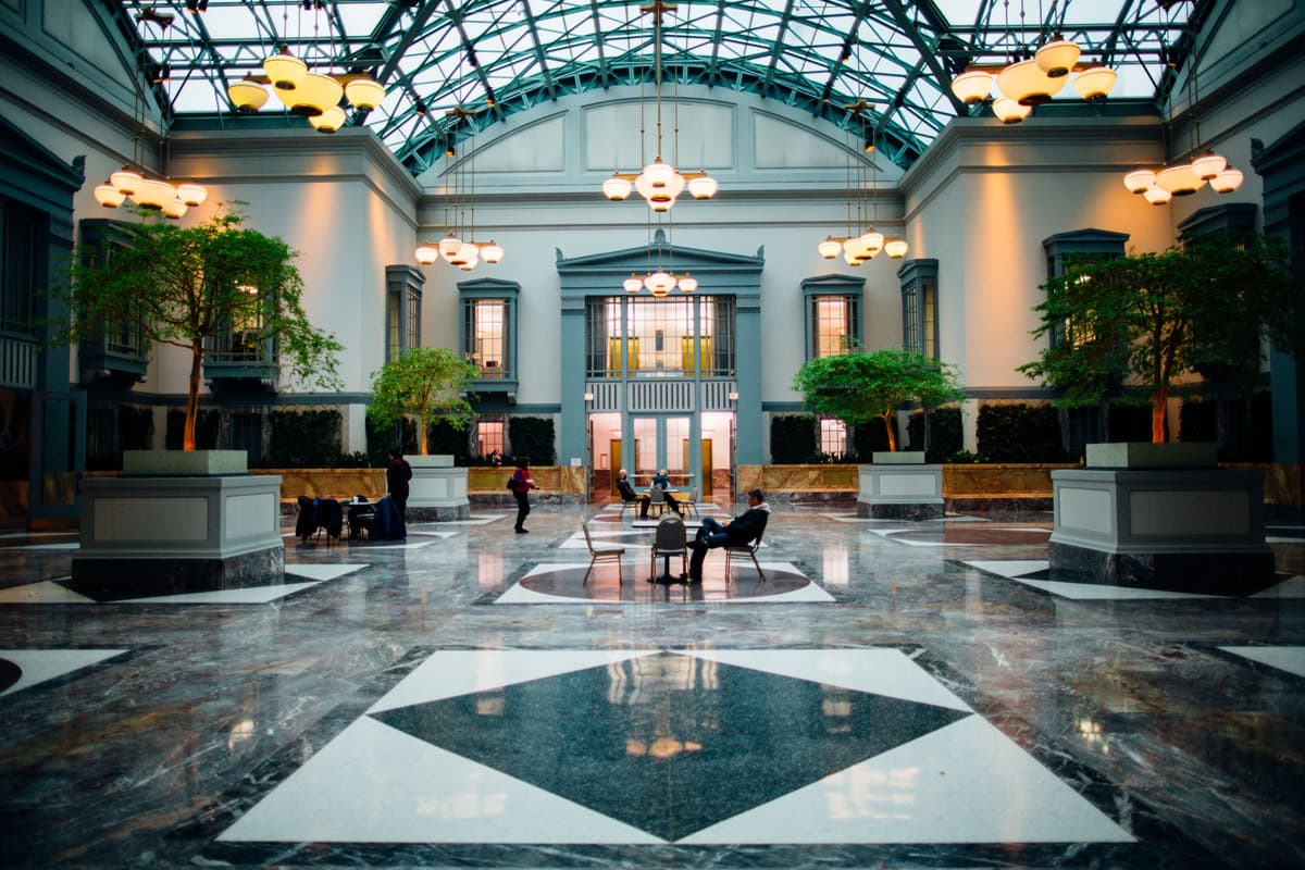 A grand hotel lobby with a glass atrium and marble floor: an illustrative image for hospitality venues.