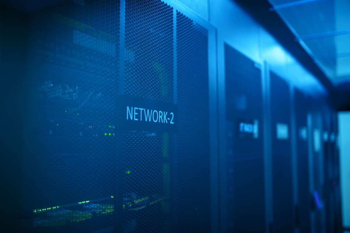 Rows of network server racks in a data centre: an illustrative image for applied AI infrastructure.