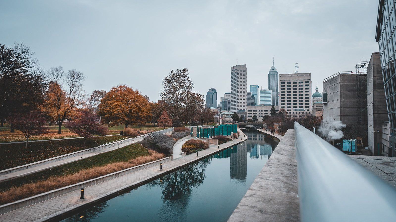 A canal and park beside the Indianapolis skyline in autumn: an illustrative image of Indiana.