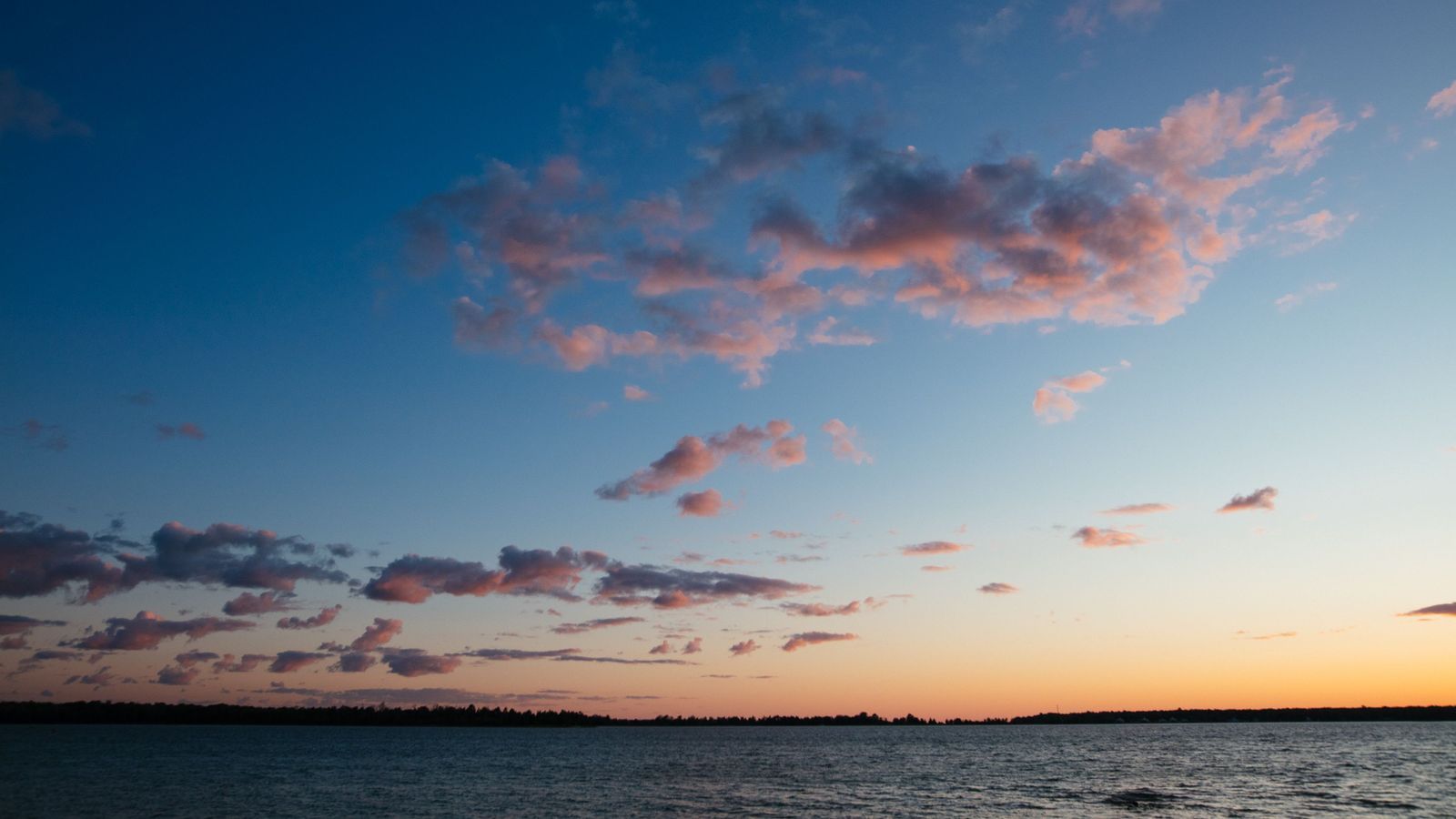 Sunset clouds over Lake Michigan in Wisconsin: an illustrative image of the state.